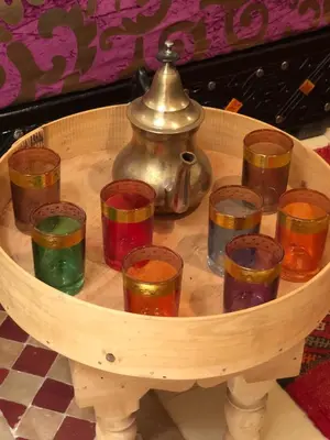 a group of glasses in a table with a tea pot at Riad Côté palmeraie in Marrakech