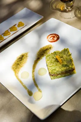 a white plate with a piece of cake on it at Dar Rhizlane, Palais Table d'hôtes & SPA in Marrakech