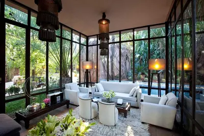 a living room with white furniture and large windows at Dar Rhizlane, Palais Table d'hôtes & SPA in Marrakech