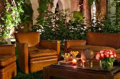 a living room with two chairs and a coffee table at Dar Rhizlane, Palais Table d'hôtes & SPA in Marrakech