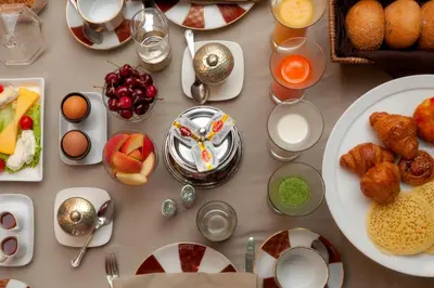a table topped with plates of food and drinks at Dar Rhizlane, Palais Table d'hôtes & SPA in Marrakech