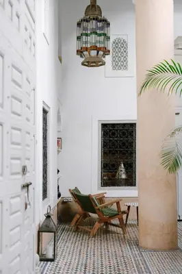 a room with a chair and a chandelier at Dar Lalla F'dila in Marrakech