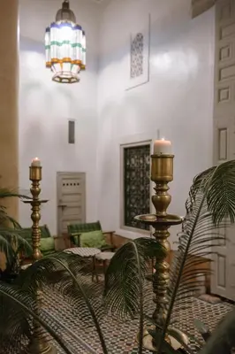 a living room with a couch and a chandelier at Dar Lalla F'dila in Marrakech