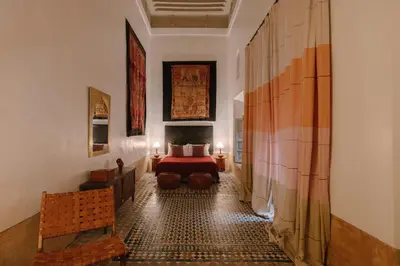 a hotel room with a bed and a couch at Dar Lalla F'dila in Marrakech