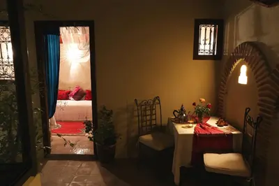 a room with a table and a room with a bedroom at Riad Zehar & Spa Marrakech in Marrakech