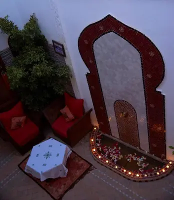 a mirror in a living room with christmas lights at Riad Zehar & Spa Marrakech in Marrakech