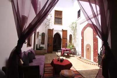 a living room with a couch and a table at Riad Zehar & Spa Marrakech in Marrakech