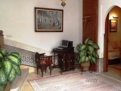 a living room with a piano and a plant at Riad Viva in Marrakech