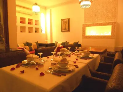 a dining room with a table with dishes on it at Riad Viva in Marrakech