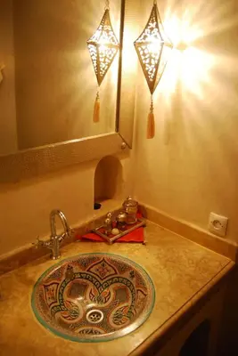 a bathroom with a sink and a mirror and lights at Riad Viva in Marrakech