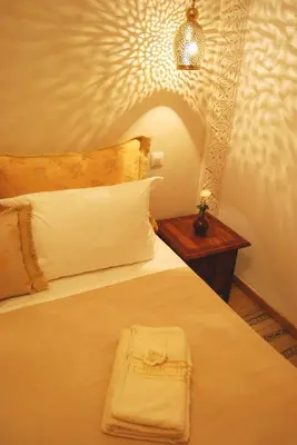 a hotel room with a bed with a towel on it at Riad Viva in Marrakech