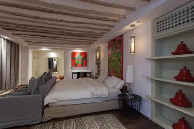 a bedroom with a bed and a couch at BCK Art Riad in Marrakech