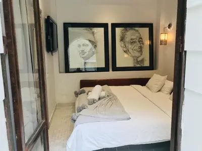 a bedroom with a bed with pictures on the wall at BCK Art Riad in Marrakech
