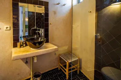a bathroom with a sink and a shower at Riad Les Jardins des Lilas in Marrakech