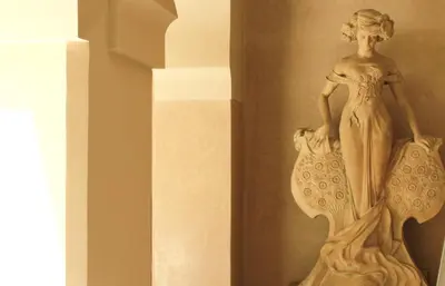 a statue of a woman on the side of a wall at Villa Makassar in Marrakech