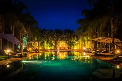 a pool at a resort at night at Palais Mirage d'Atlas, Hôtel & Spa in Marrakech