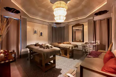 a therapy room with two beds and a couch at Palais Mirage d'Atlas, Hôtel & Spa in Marrakech