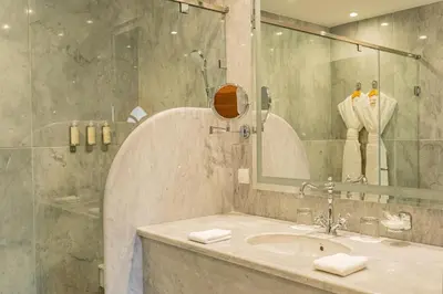 a bathroom with a sink and a mirror at La Maison Arabe Hotel, Spa & Cooking Workshops in Marrakech