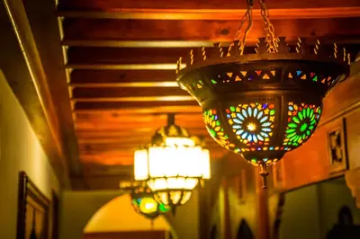 a stained glass chandelier hanging from a ceiling with lights at Riad Belle Epoque in Marrakech