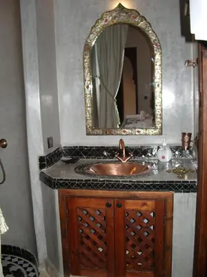 a bathroom with a sink and a mirror at Riad Belle Epoque in Marrakech
