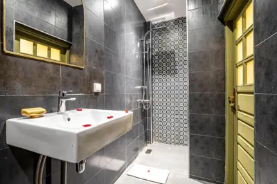a bathroom with a white sink and a shower at Riad Hamdane Rooftop & SPA in Marrakech