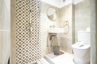 a bathroom with a toilet and a sink and a mirror at Riad Hamdane Rooftop & SPA in Marrakech