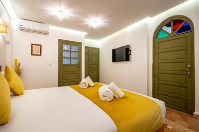 a bedroom with a bed with towels on it at Riad Hamdane Rooftop & SPA in Marrakech