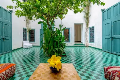 a room with green and yellow flooring and a tree at Hotel & Spa Dar Sara in Marrakech