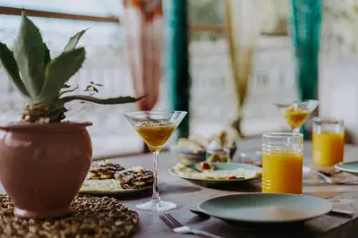 a table with plates of food and glasses of orange juice at Riad 117 in Marrakech