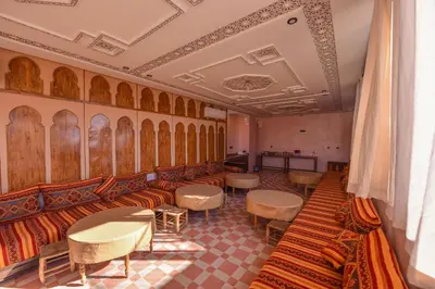 a waiting room with couches and tables at Riad Assia in Marrakech