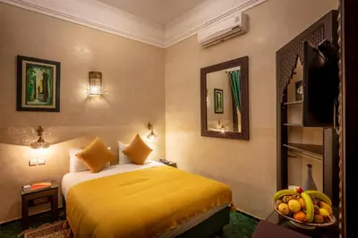 a hotel room with a bed and a bowl of fruit at Riad & Spa Bahia Salam in Marrakech