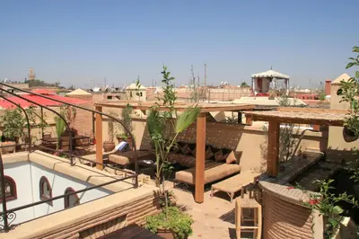 a rooftop patio with a view of a city at Riad L'Emir in Marrakech