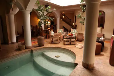 a pool in the middle of a living room at Riad L'Emir in Marrakech