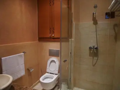 a small bathroom with a toilet and a shower at Jnane Gueliz in Marrakech