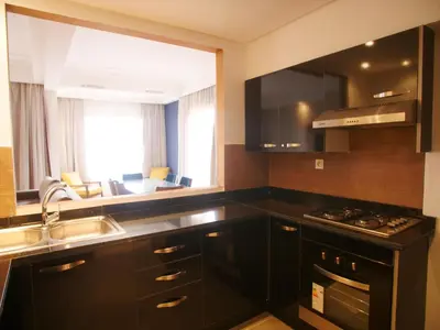 a kitchen with black cabinets and a sink at Jnane Gueliz in Marrakech