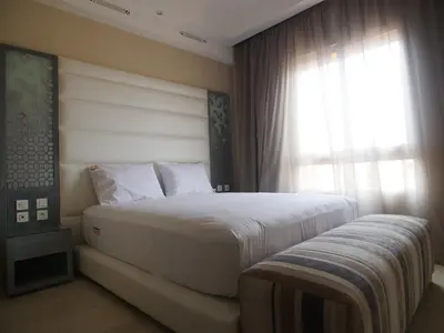 a bedroom with a large bed and a window at Jnane Gueliz in Marrakech