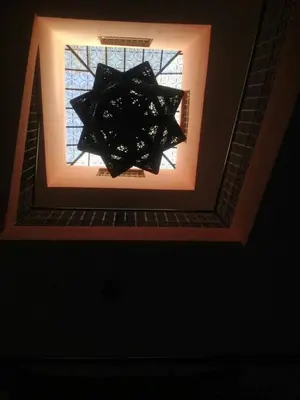 a chandelier hanging from a ceiling with a window at Ryad Nayla in Marrakech