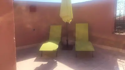two chairs sitting next to each other in a room at Ryad Nayla in Marrakech