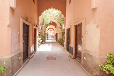 an alley way between two buildings with an archway at Ryad Nayla in Marrakech