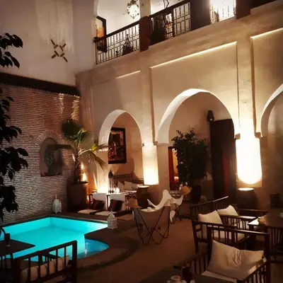 a living room with a pool in a building at Riad Amira in Marrakech