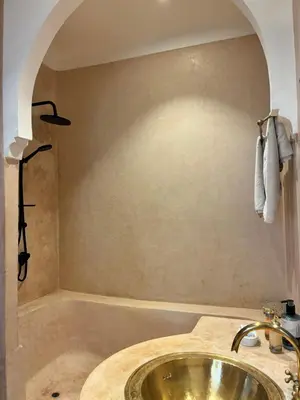 a bathroom with a sink and a bath tub at Riad Chameau FDC Hôtel SPA in Marrakech