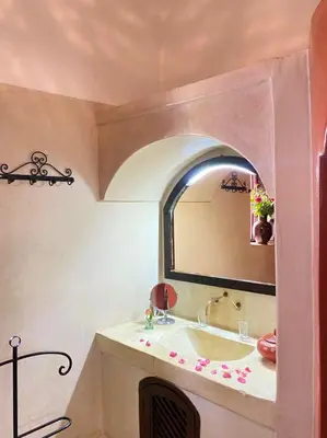 a bathroom with a sink and a mirror at Dar Soukaina in Marrakech