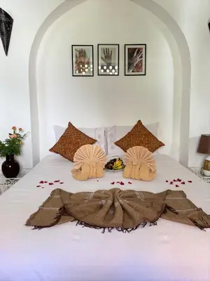 a bedroom with a bed with flowers on it at Dar Soukaina in Marrakech