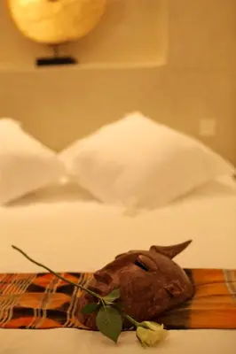 a small animal head on a cutting board on a bed at Riad Dar Ten in Marrakech