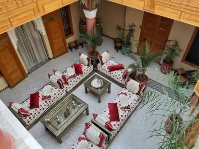 an overhead view of a living room with red and white pillows at Riad Miral in Marrakech