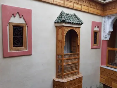 a building with a bird house on the side of it at Riad Miral in Marrakech
