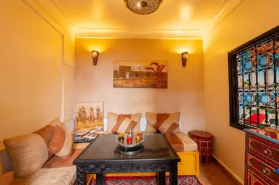 a living room with a couch and a table at Riad Mboja Chez Ali Baba in Marrakech