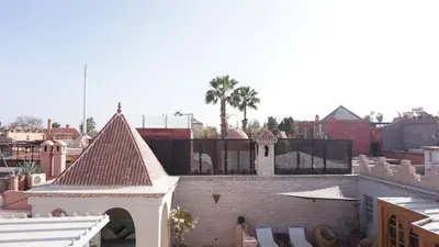 arial view of a city with buildings and palm trees at Riad Samsli in Marrakech