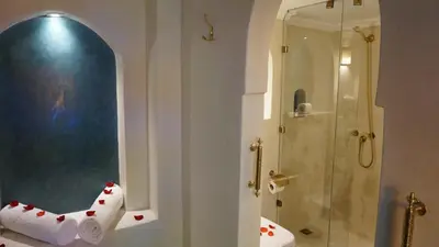 a bathroom with a shower and a toilet paper dispenser at Riad Samsli in Marrakech
