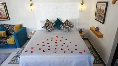 a bedroom with a bed with red hearts on it at Riad Samsli in Marrakech